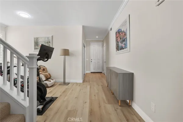 a view of a livingroom with wooden floor and stairs