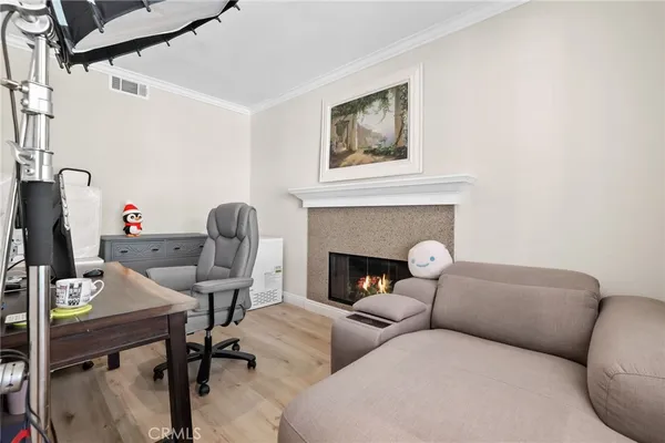 a living room with stainless steel appliances kitchen island granite countertop furniture and a wooden floor