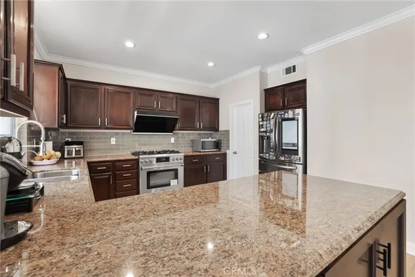 a kitchen with lots of counter top space sink and wooden floor