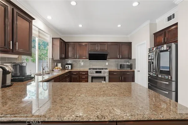 a kitchen with a sink stove and cabinets
