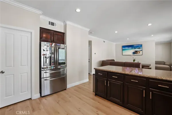 a view of a hallway with wooden floor and entryway