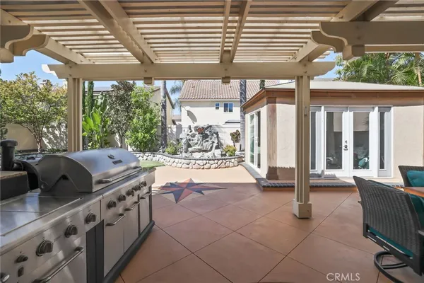 a view of a house with backyard sitting area and swimming pool