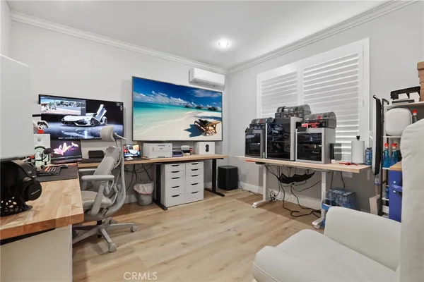 a view of a workspace with furniture and a window