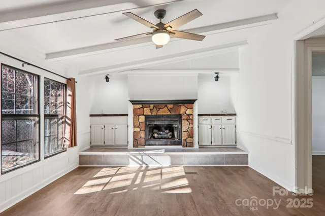 a view of an empty room with window and cabinet