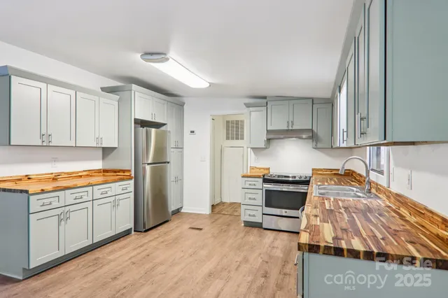 a kitchen with granite countertop a sink and a stove