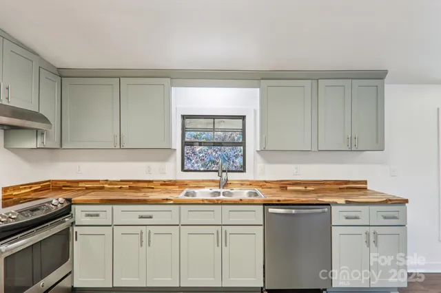 a large kitchen with a wooden floor and cabinets