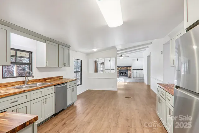a kitchen with granite countertop a sink stove and cabinets