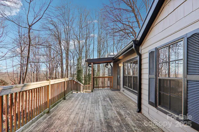 a view of a porch with wooden floor and furniture