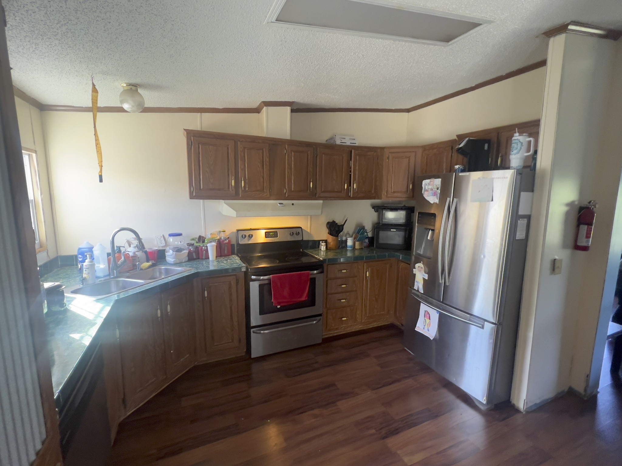 245 North Centerpoint Road Portland, TN 37148 - Photo 3 of 18 a kitchen with granite countertop a refrigerator stove and wooden floor