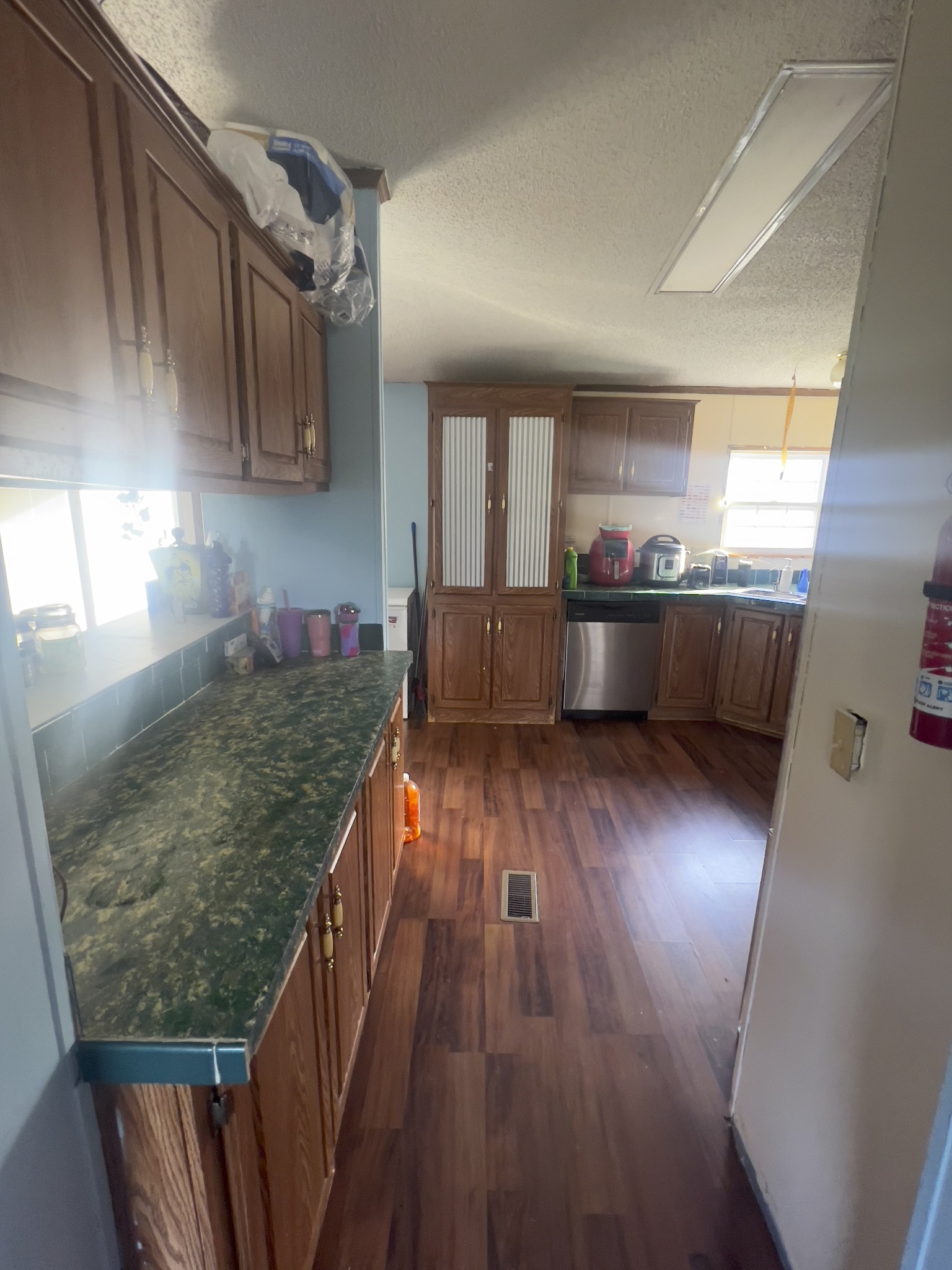 245 North Centerpoint Road Portland, TN 37148 - Photo 4 of 18 a kitchen with granite countertop white cabinets and wooden floor
