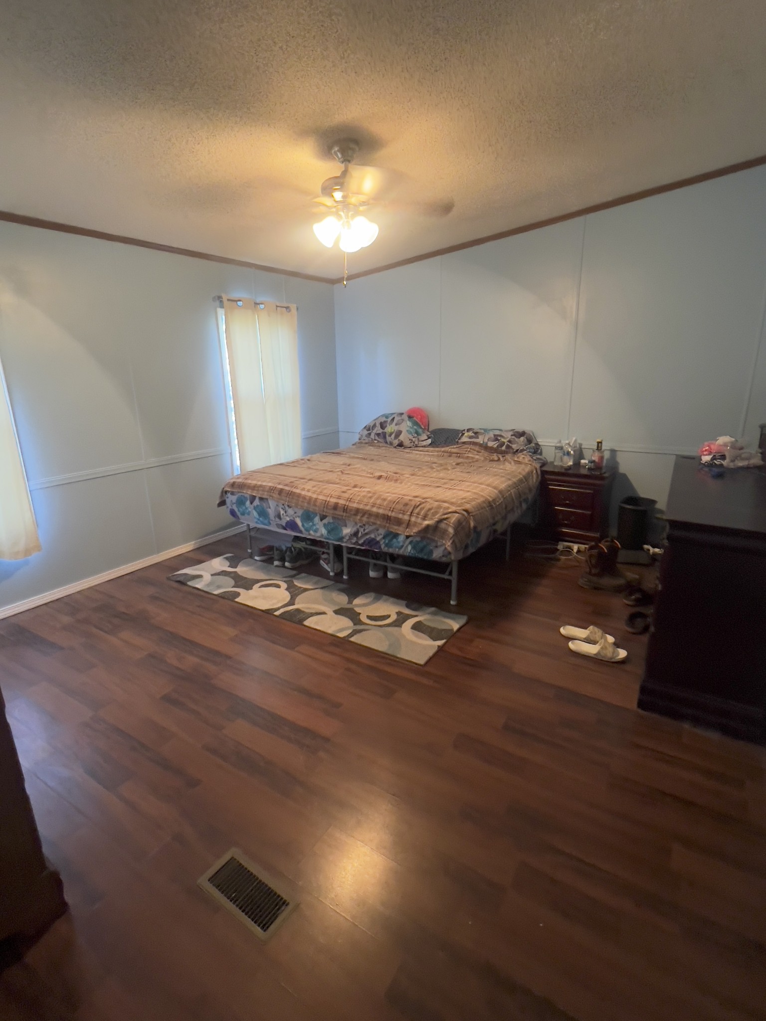 245 North Centerpoint Road Portland, TN 37148 - Photo 9 of 18 a spacious bedroom with a bed and a dresser with wooden floor