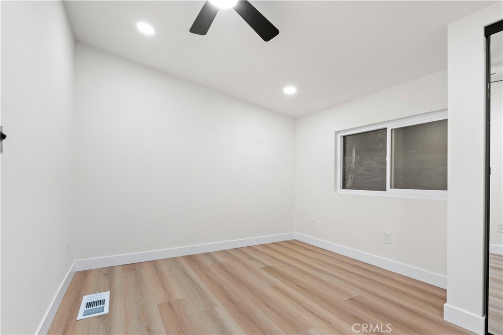33195 Meyer Road Nuevo, CA 92567 - Photo 13 of 36 an empty room with wooden floor and windows