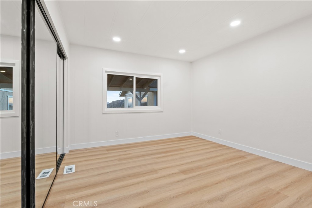 33195 Meyer Road Nuevo, CA 92567 - Photo 18 of 36 a view of empty room with wooden floor and fan