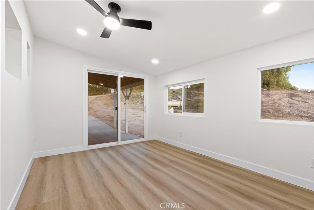 33195 Meyer Road Nuevo, CA 92567 - Photo 19 of 36 a view of an empty room with window and wooden floor