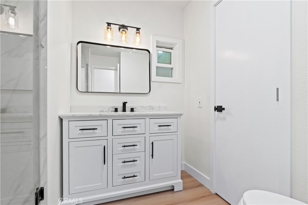 33195 Meyer Road Nuevo, CA 92567 - Photo 23 of 36 a bathroom with mirror a sink and a toilet