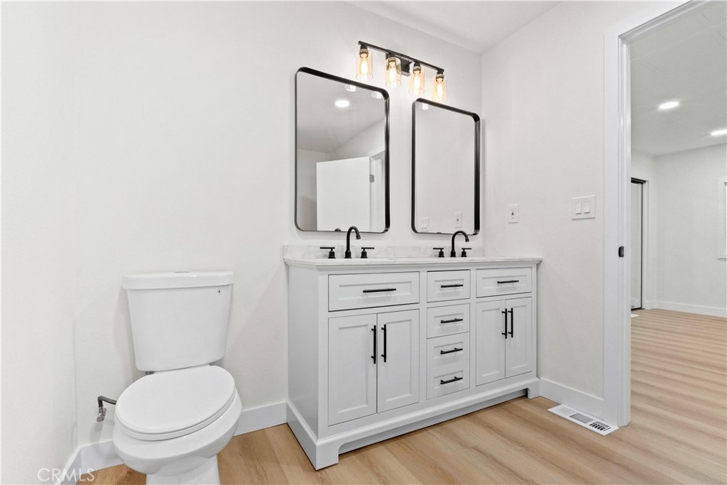 33195 Meyer Road Nuevo, CA 92567 - Photo 25 of 36 a bathroom with a toilet a sink a mirror and vanity