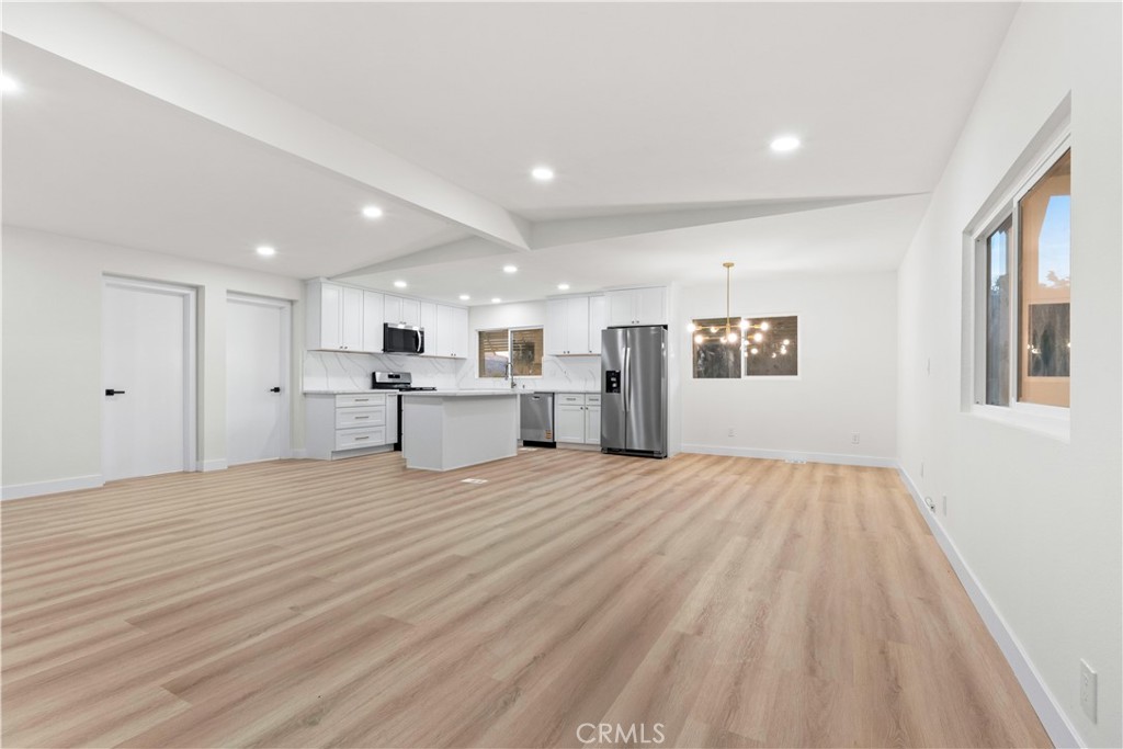 33195 Meyer Road Nuevo, CA 92567 - Photo 7 of 36 a view of a kitchen with a sink and dishwasher with wooden floor