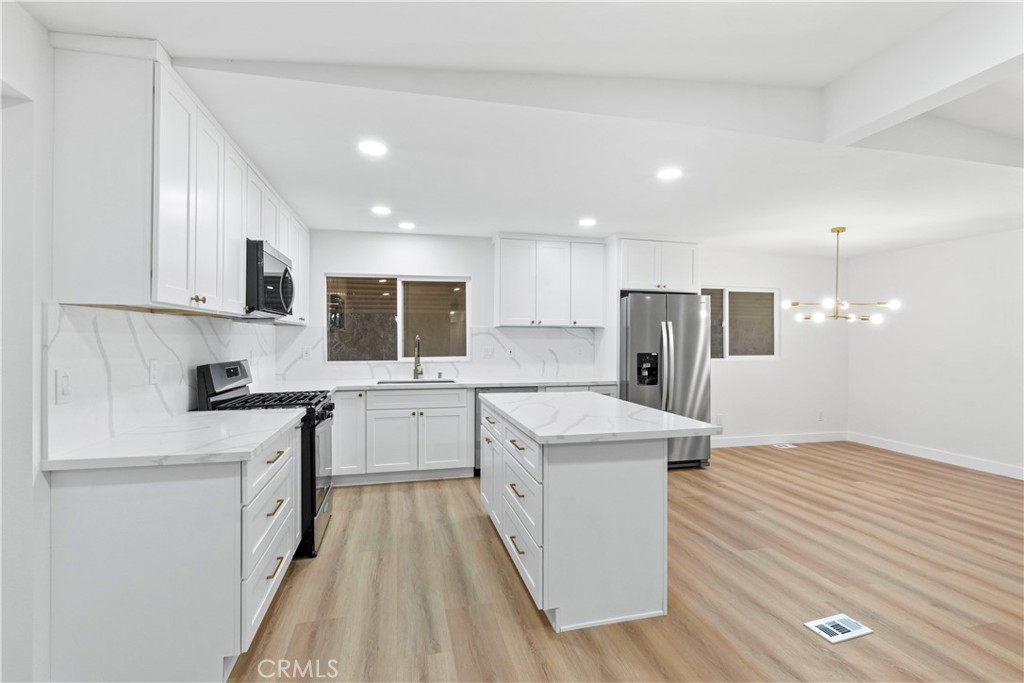 33195 Meyer Road Nuevo, CA 92567 - Photo 9 of 36 a kitchen with a sink stove and refrigerator
