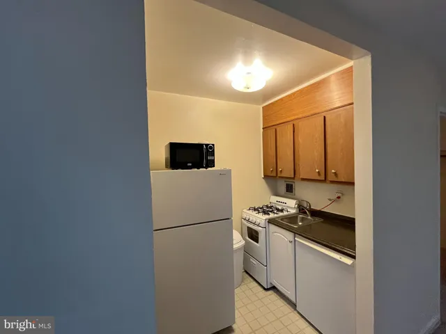 a kitchen with a refrigerator and a stove