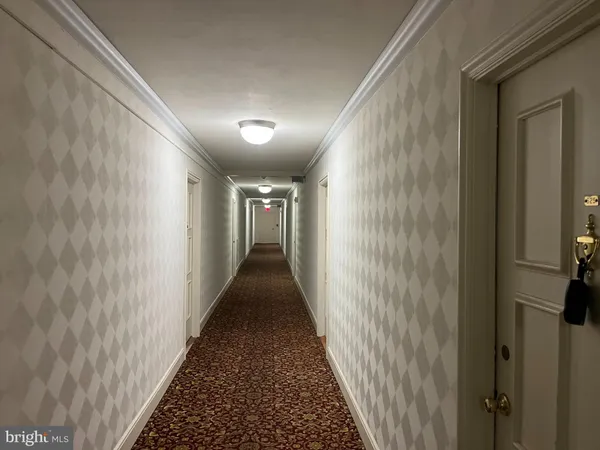 a view of a hallway with a wooden floor