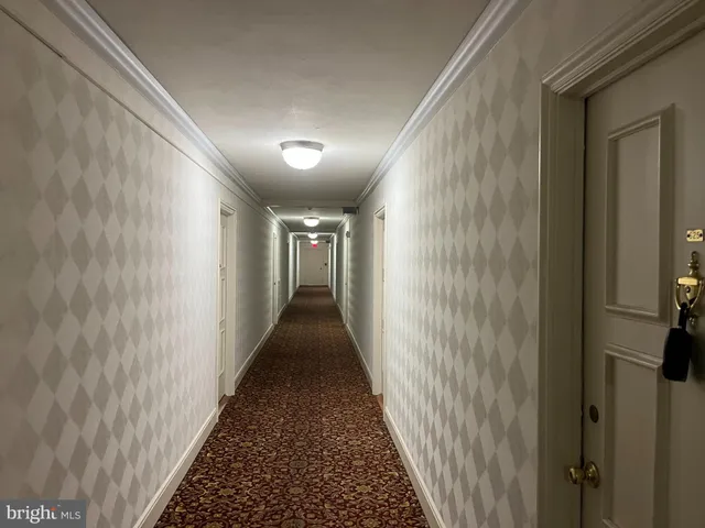 a view of a hallway with a wooden floor