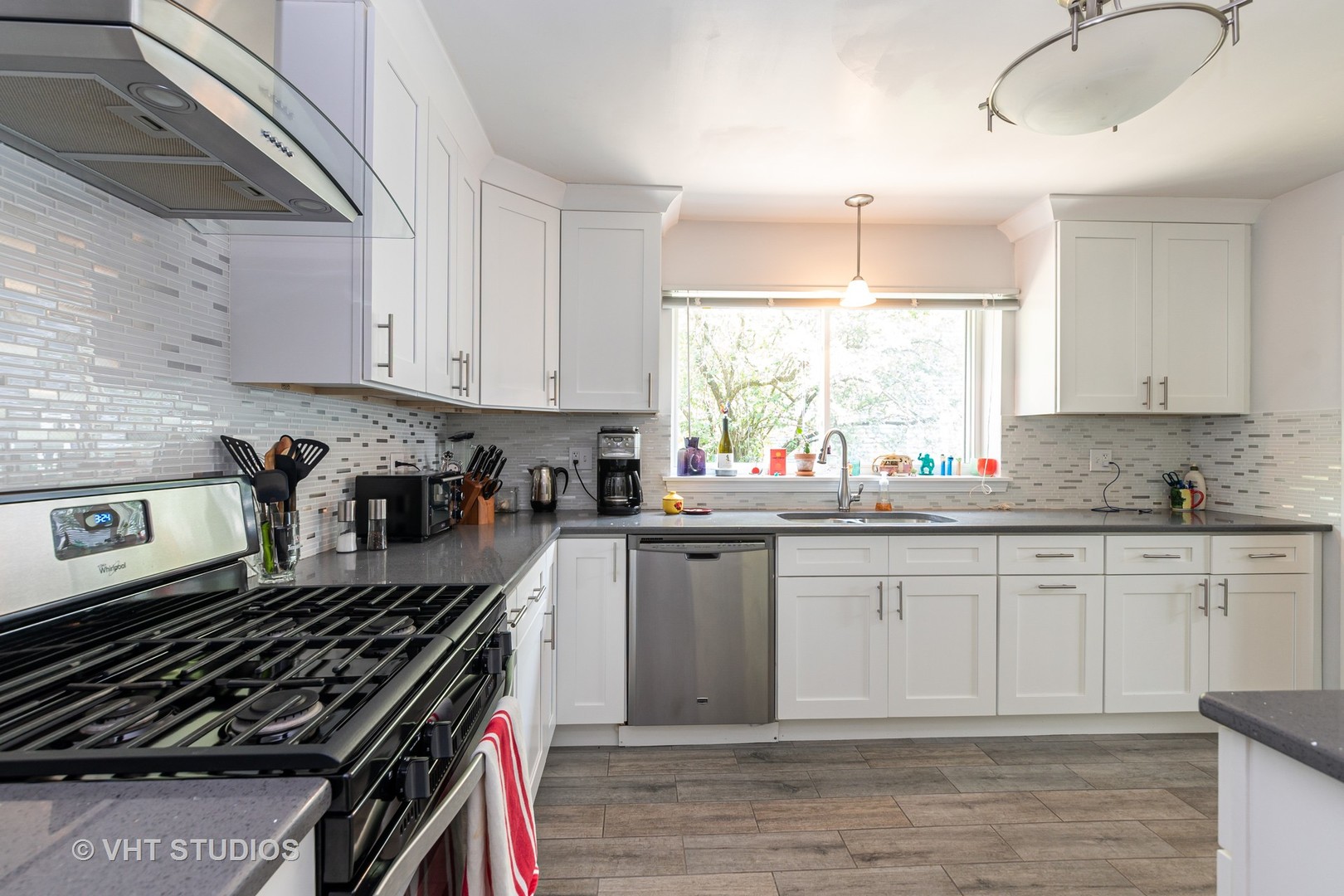 1307 Ridge Road Highland Park, IL 60035 - Photo 2 of 10 a kitchen with granite countertop a stove a sink and dishwasher wooden cabinets with granite countertops