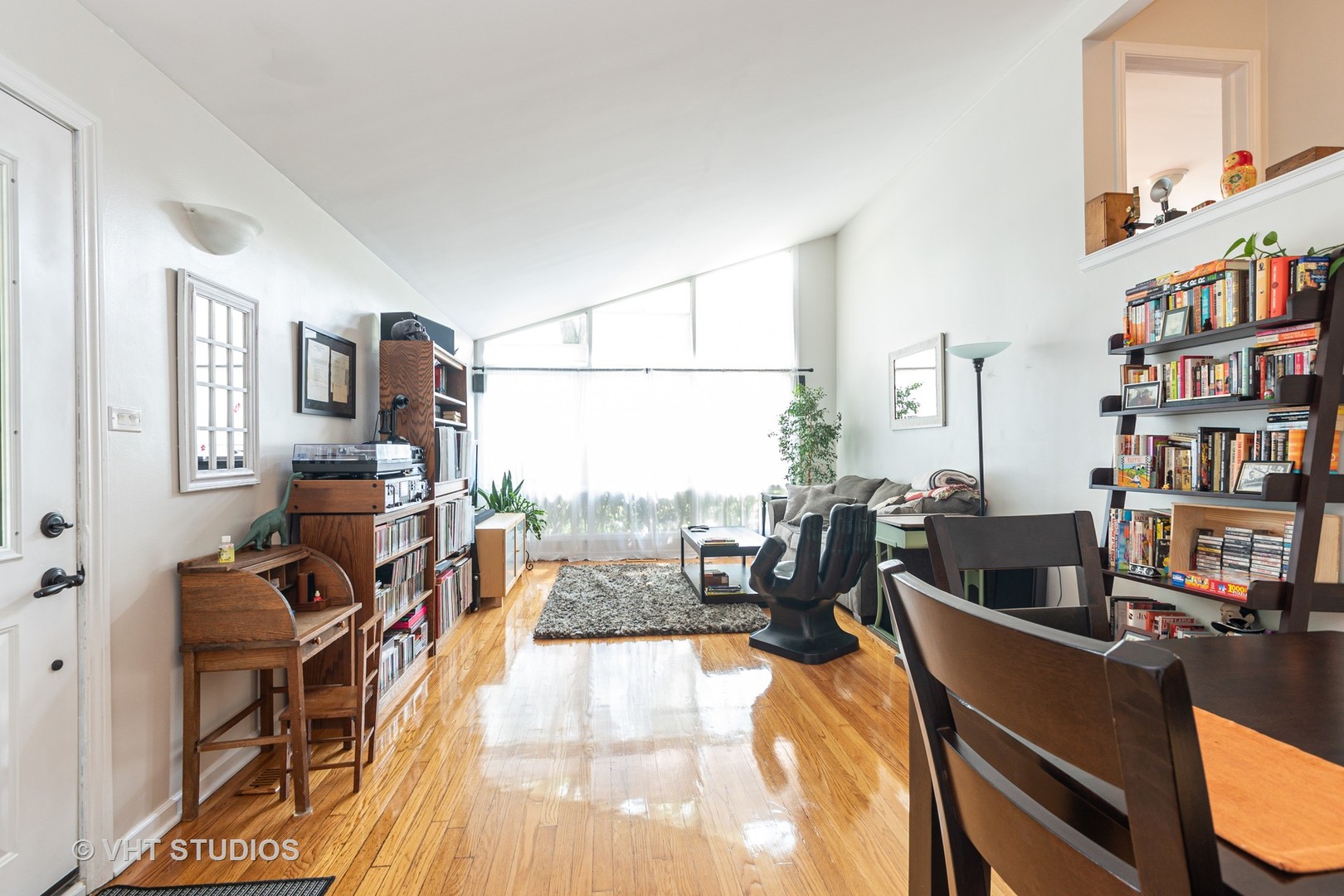 1307 Ridge Road Highland Park, IL 60035 - Photo 4 of 10 a living room with furniture a flat screen tv and a book shelf