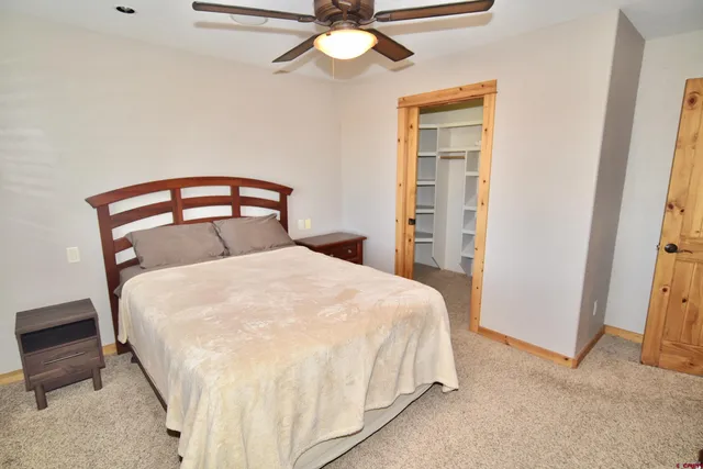 a large bed sitting in a bedroom next to a window