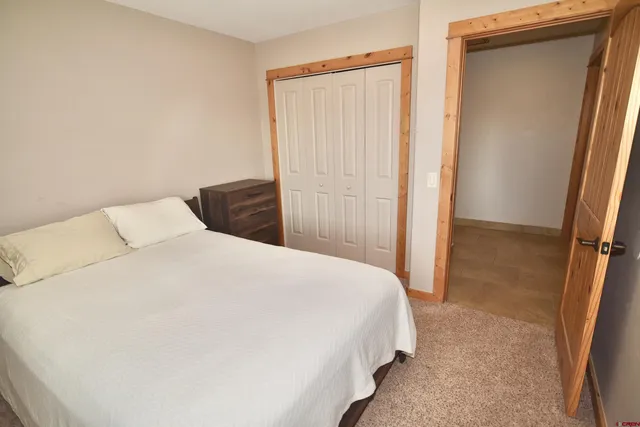 a bedroom with a bed and a mirror