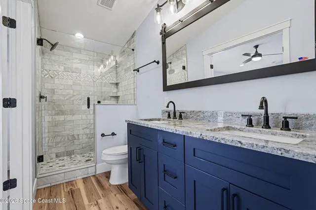 a bathroom with a granite countertop sink mirror and double