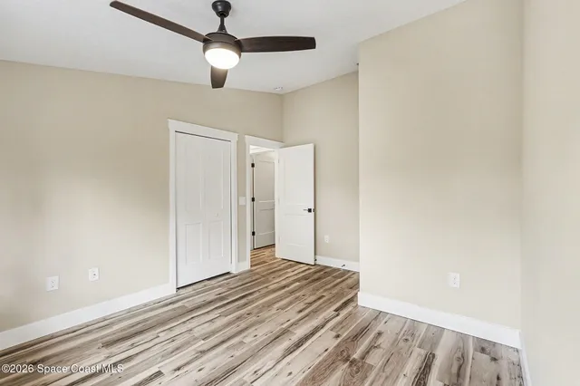 a view of empty room with wooden floor