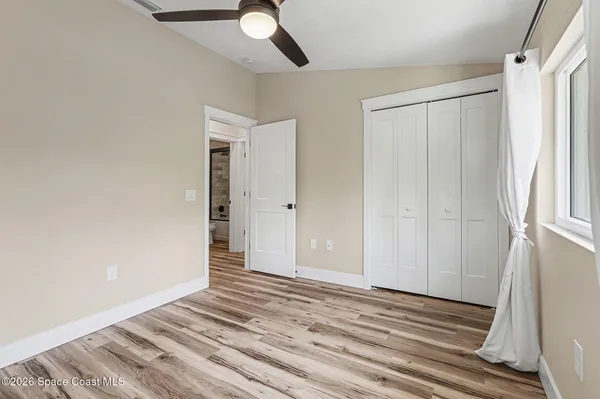 a view of a livingroom with wooden floor and closet