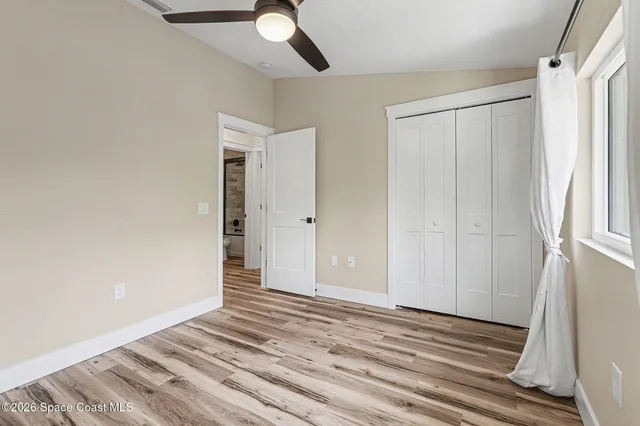 a view of a livingroom with wooden floor and closet