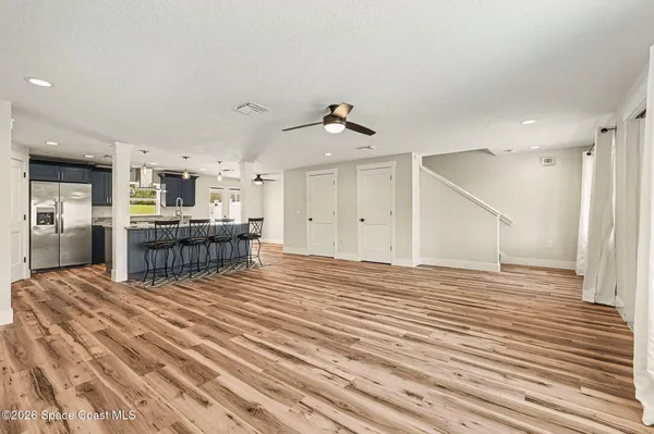a view of kitchen and kitchen with furniture and a ceiling fan