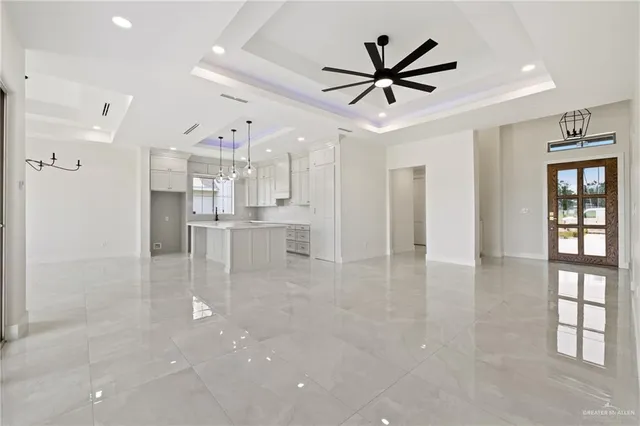 a view of a livingroom with a ceiling fan and window