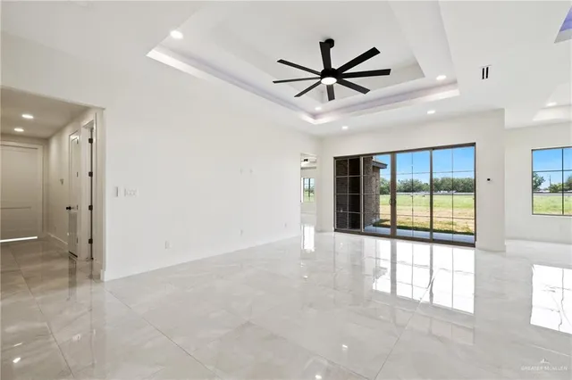a view of a livingroom with a ceiling fan and window