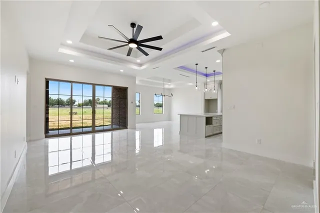 a view of a livingroom with a ceiling fan and window