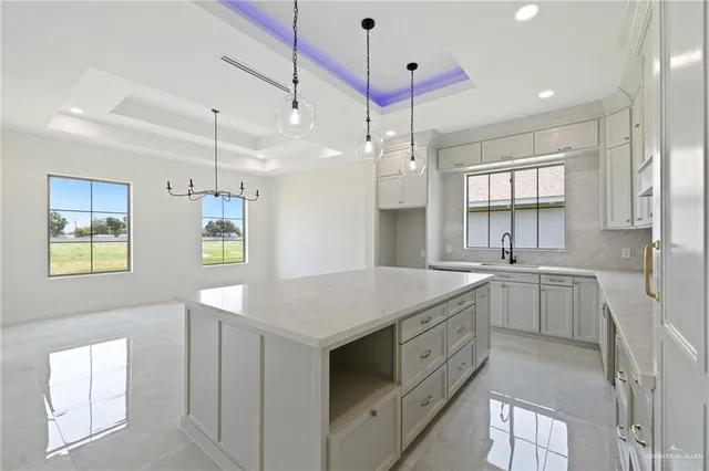a kitchen that has a sink a window and stainless steel appliances