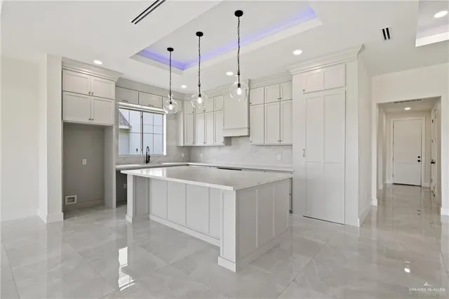 a large kitchen with cabinets a sink and a stove