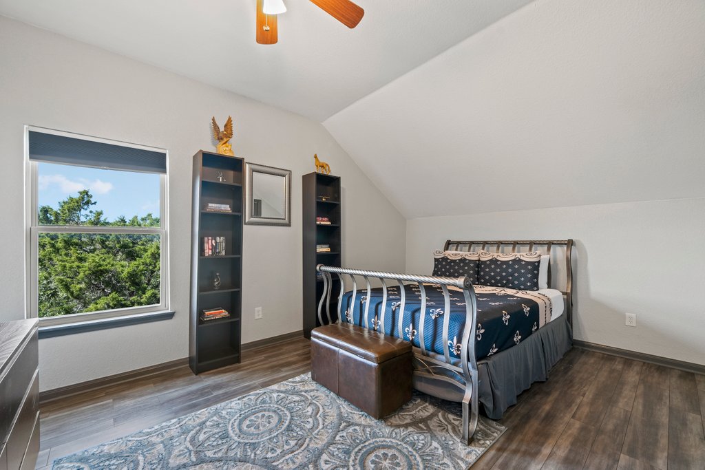 209 Lakeview Circle Spring Branch, TX 78070 - Photo 24 of 40 Bedroom featuring lofted ceiling, a ceiling fan, baseboards, and wood finished floors