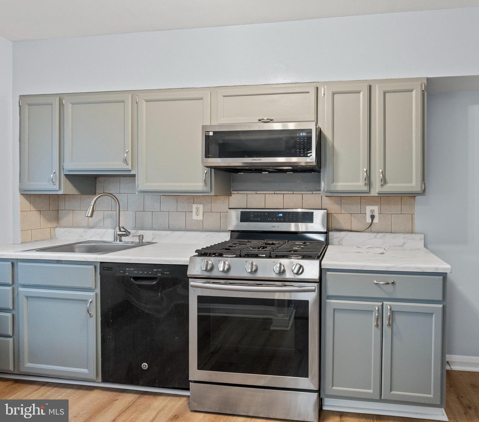 574 Brisbane Road Baltimore, MD 21229 - Photo 13 of 38 a kitchen with a stove and a sink