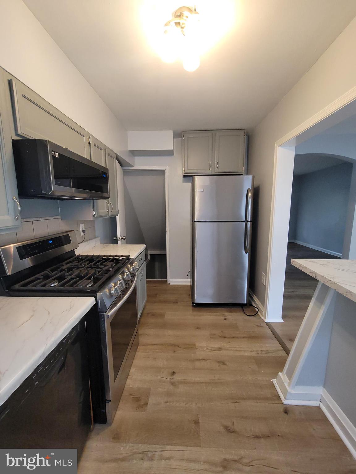 574 Brisbane Road Baltimore, MD 21229 - Photo 14 of 38 a kitchen with a stove a refrigerator and a microwave