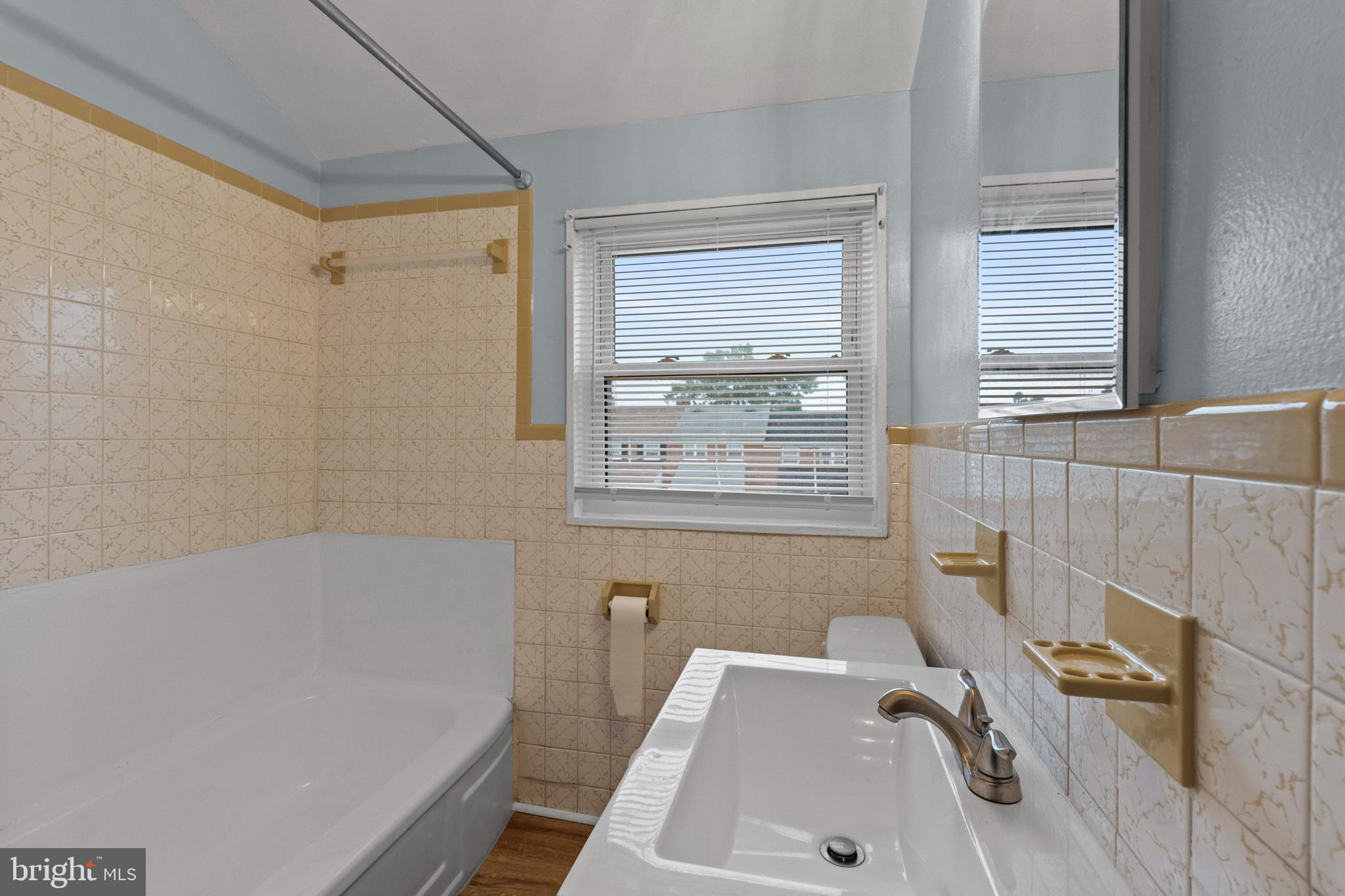 574 Brisbane Road Baltimore, MD 21229 - Photo 15 of 38 a bath tub sitting in a bathroom next to a window