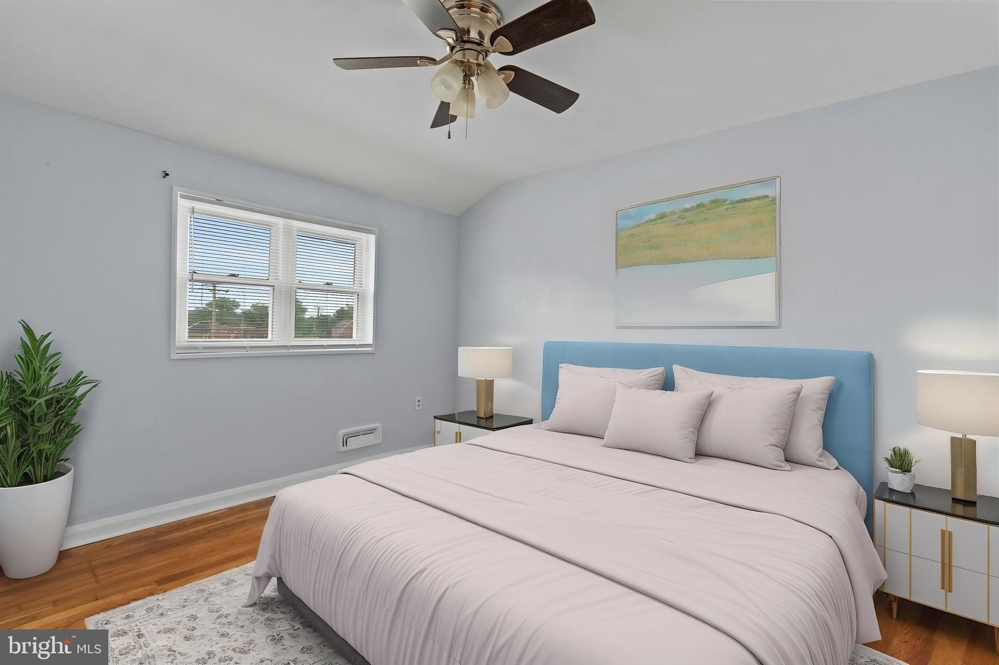 574 Brisbane Road Baltimore, MD 21229 - Photo 16 of 38 a bedroom with a bed and a potted plant