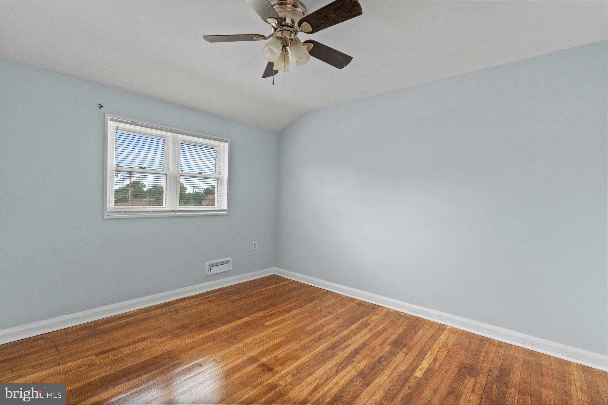 574 Brisbane Road Baltimore, MD 21229 - Photo 17 of 38 wooden floor in an empty room with a window