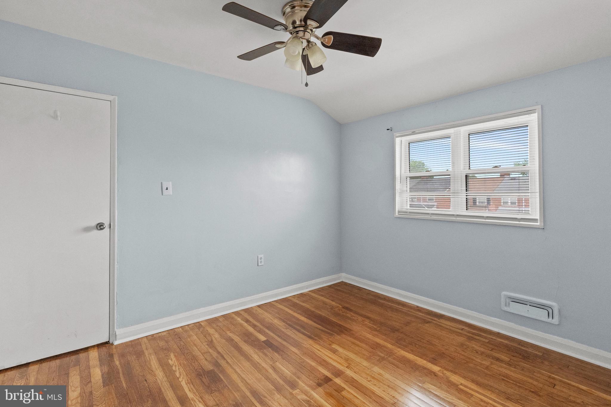 574 Brisbane Road Baltimore, MD 21229 - Photo 20 of 38 a view of empty room with wooden floor and fan