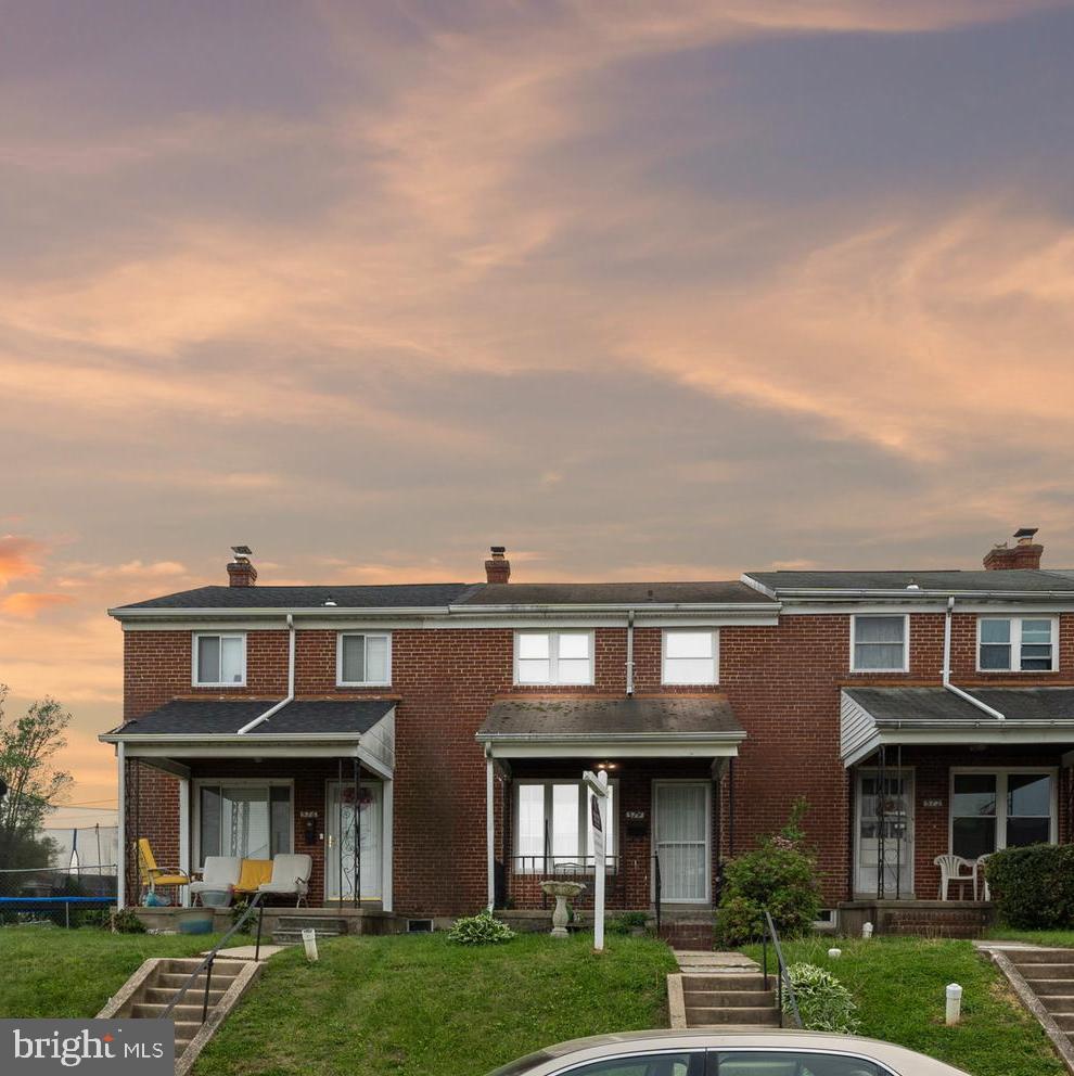 574 Brisbane Road Baltimore, MD 21229 - Photo 2 of 38 front view of a brick house with a yard