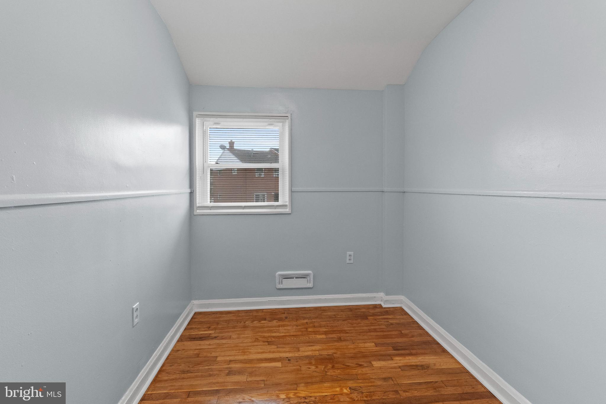 574 Brisbane Road Baltimore, MD 21229 - Photo 22 of 38 a view of a room with wooden floor and windows