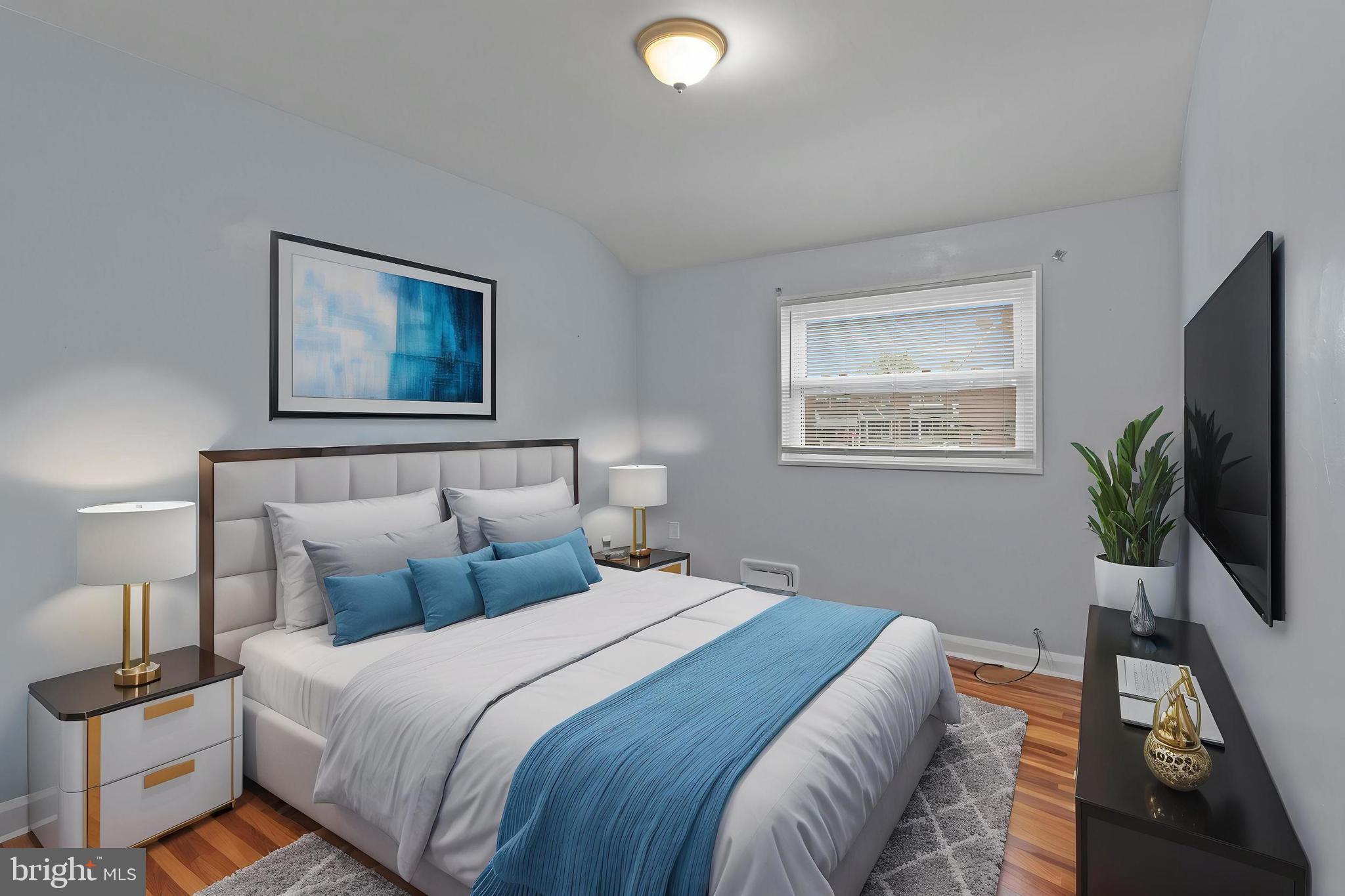 574 Brisbane Road Baltimore, MD 21229 - Photo 24 of 38 a bedroom with a bed and a flat screen tv