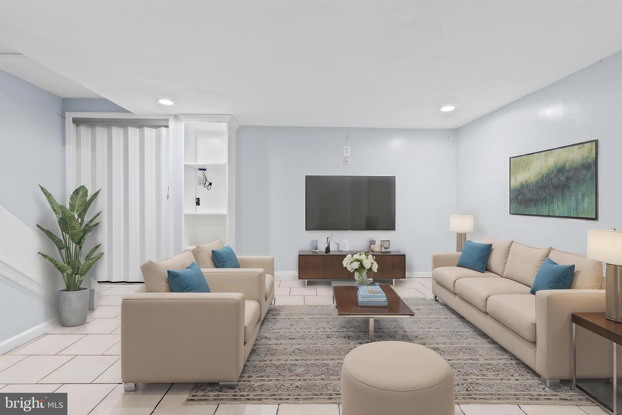 574 Brisbane Road Baltimore, MD 21229 - Photo 28 of 38 a living room with furniture a flat screen tv and a potted plant